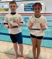 two children by a swimming pool, wearing Make  Splash t-shirts.